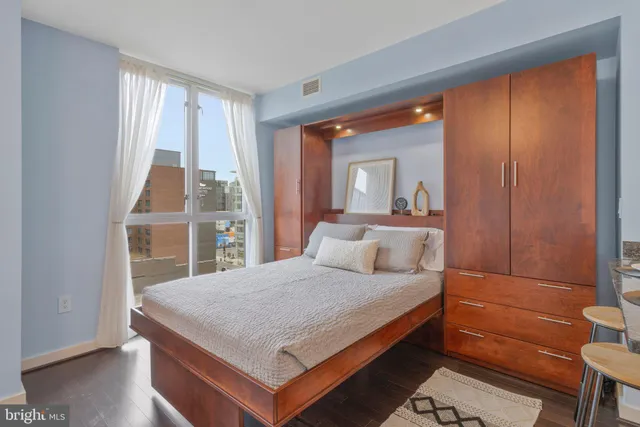 a bedroom with a bed and a dresser