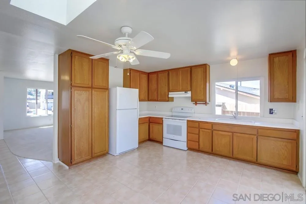 12941 Standish Drive Poway, CA 92064 - Photo 11 of 30 a large kitchen with cabinets and stainless steel appliances