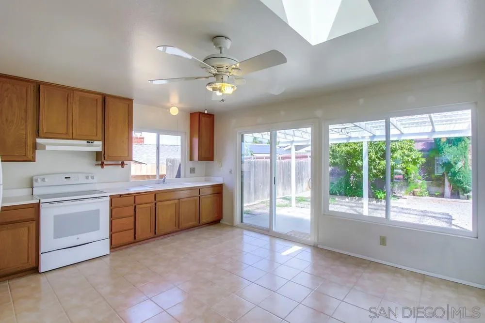 12941 Standish Drive Poway, CA 92064 - Photo 10 of 30 a large kitchen with a large window and stainless steel appliances