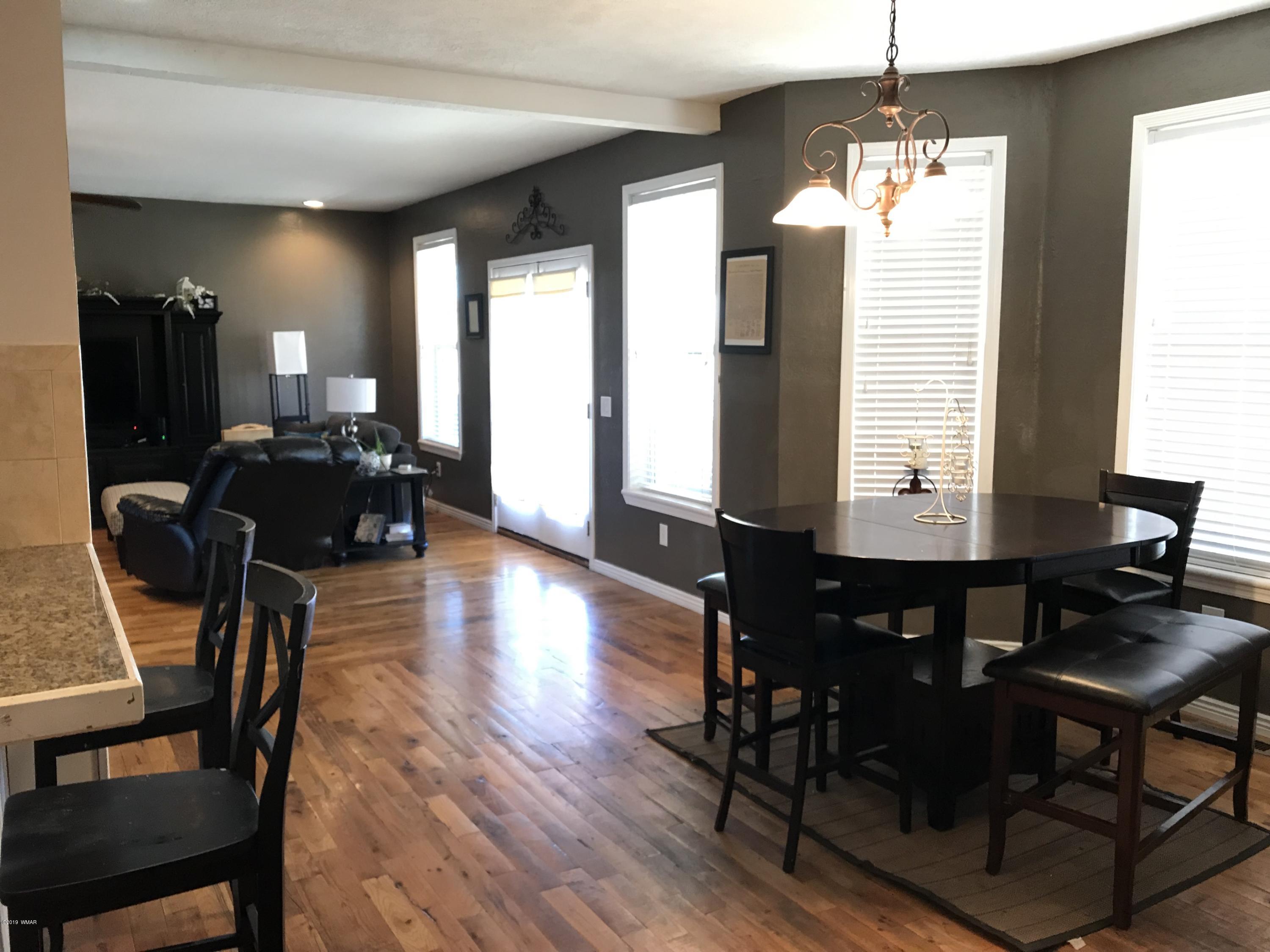 1362 Lobo Trail Snowflake, AZ 85937 - Photo 12 of 34 a view of a dining room with furniture window and wooden floor