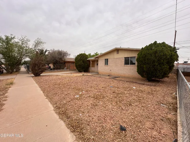 a white house with a large tree in front of it