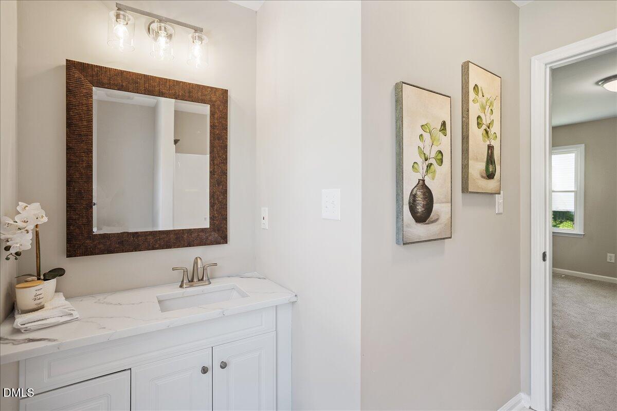 31 Fieldview Court Angier, NC 27501 - Photo 14 of 25 a bathroom with a sink and a mirror