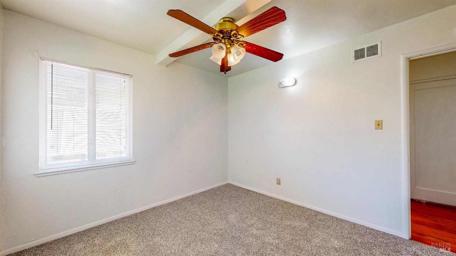 809 Maple Avenue Vallejo, CA 94591 - Photo 25 of 46 an empty room with windows and fan