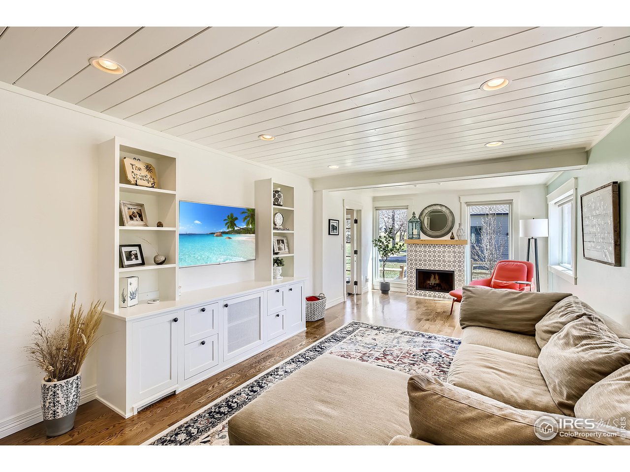 4881 Valkyrie Drive Boulder, CO 80301 - Photo 15 of 39 a living room with furniture a fireplace and a flat screen tv