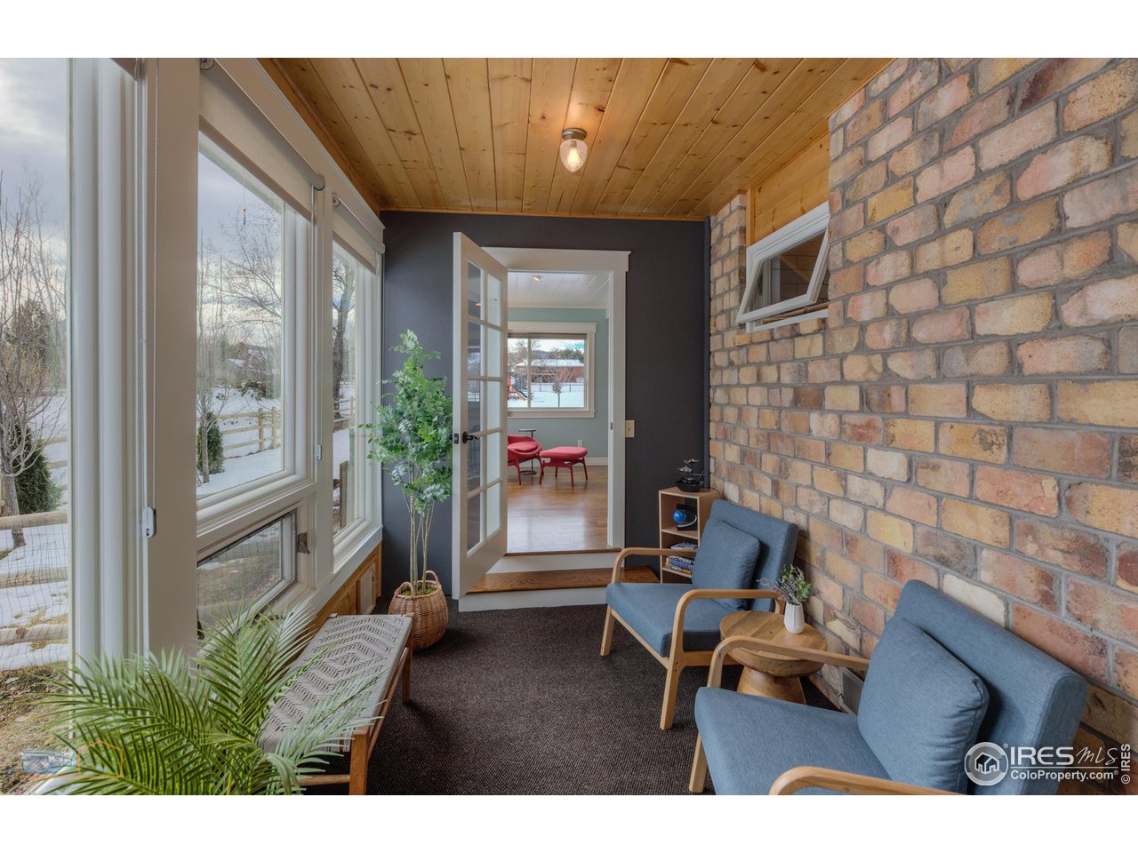 4881 Valkyrie Drive Boulder, CO 80301 - Photo 16 of 39 a living room with furniture and a floor to ceiling window