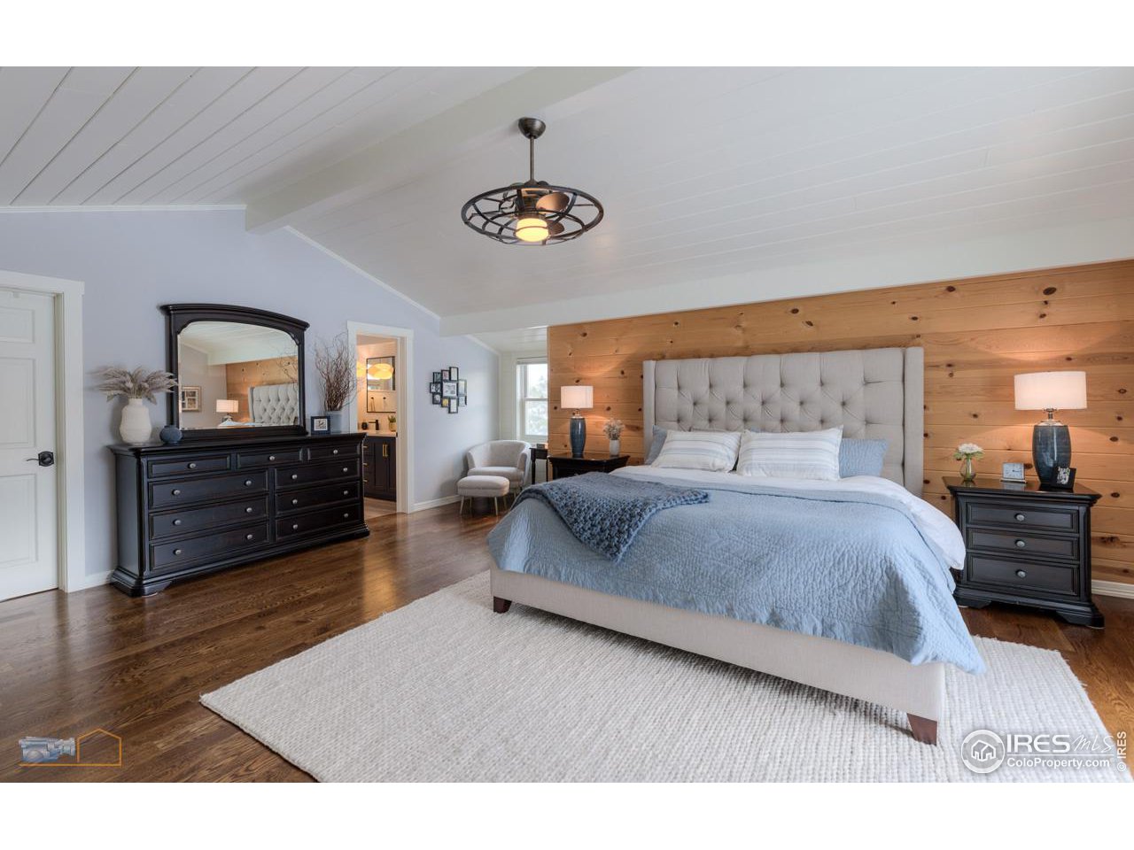 4881 Valkyrie Drive Boulder, CO 80301 - Photo 20 of 39 a bedroom with a bed and a large mirror on the dresser
