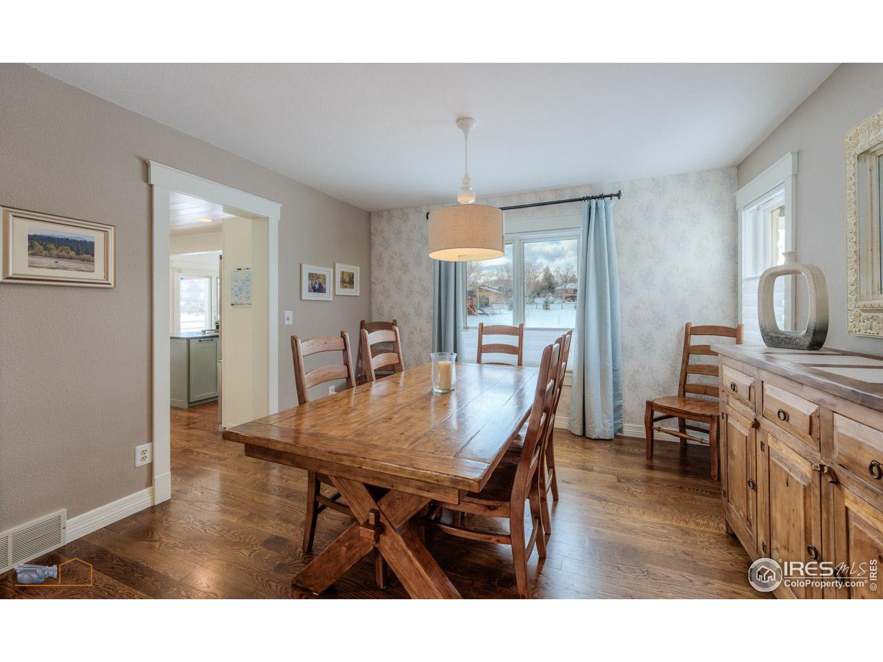 4881 Valkyrie Drive Boulder, CO 80301 - Photo 6 of 39 a dining room with wooden floor a chandelier a wooden table and chairs