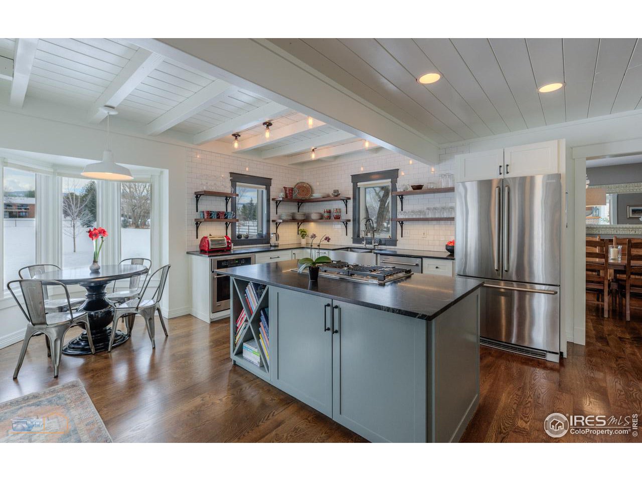 4881 Valkyrie Drive Boulder, CO 80301 - Photo 7 of 39 a kitchen with stainless steel appliances granite countertop a table chairs and a refrigerator