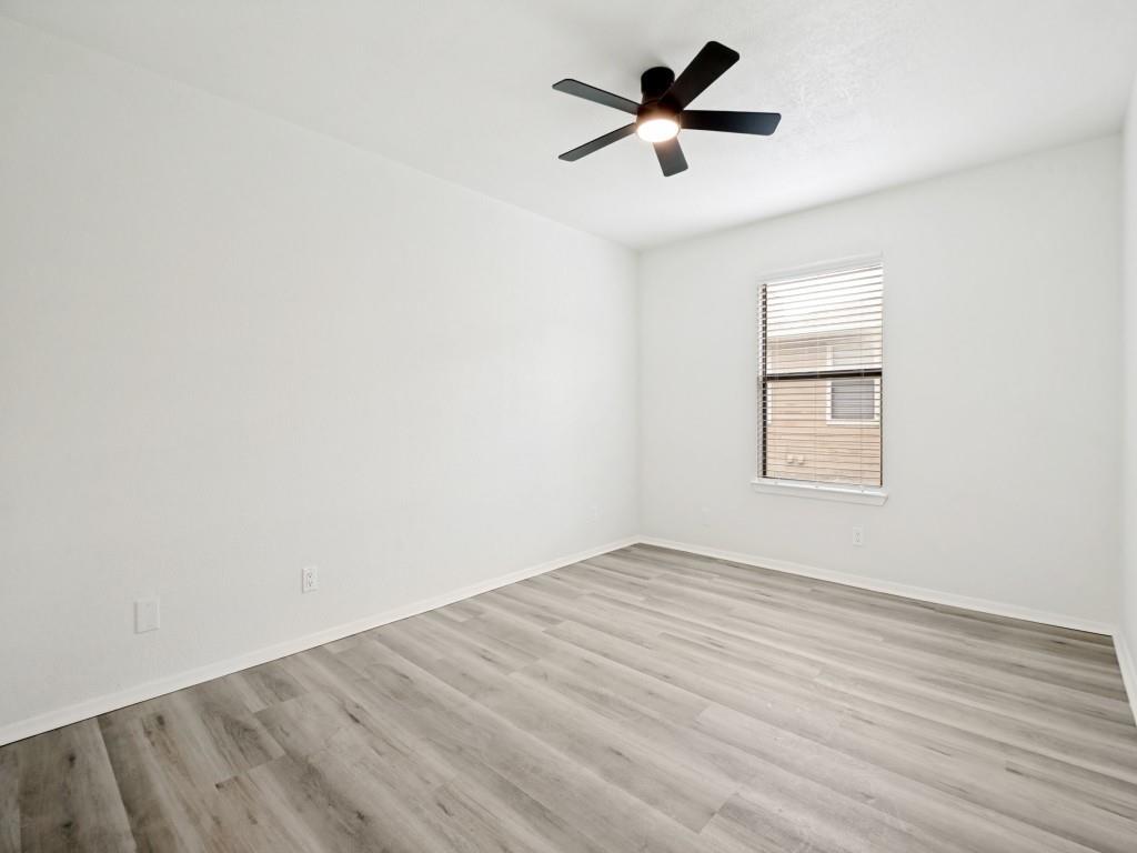 2240 Tarpley Road, Unit 92 Carrollton, TX 75006 - Photo 15 of 22 an empty room with wooden floor and windows