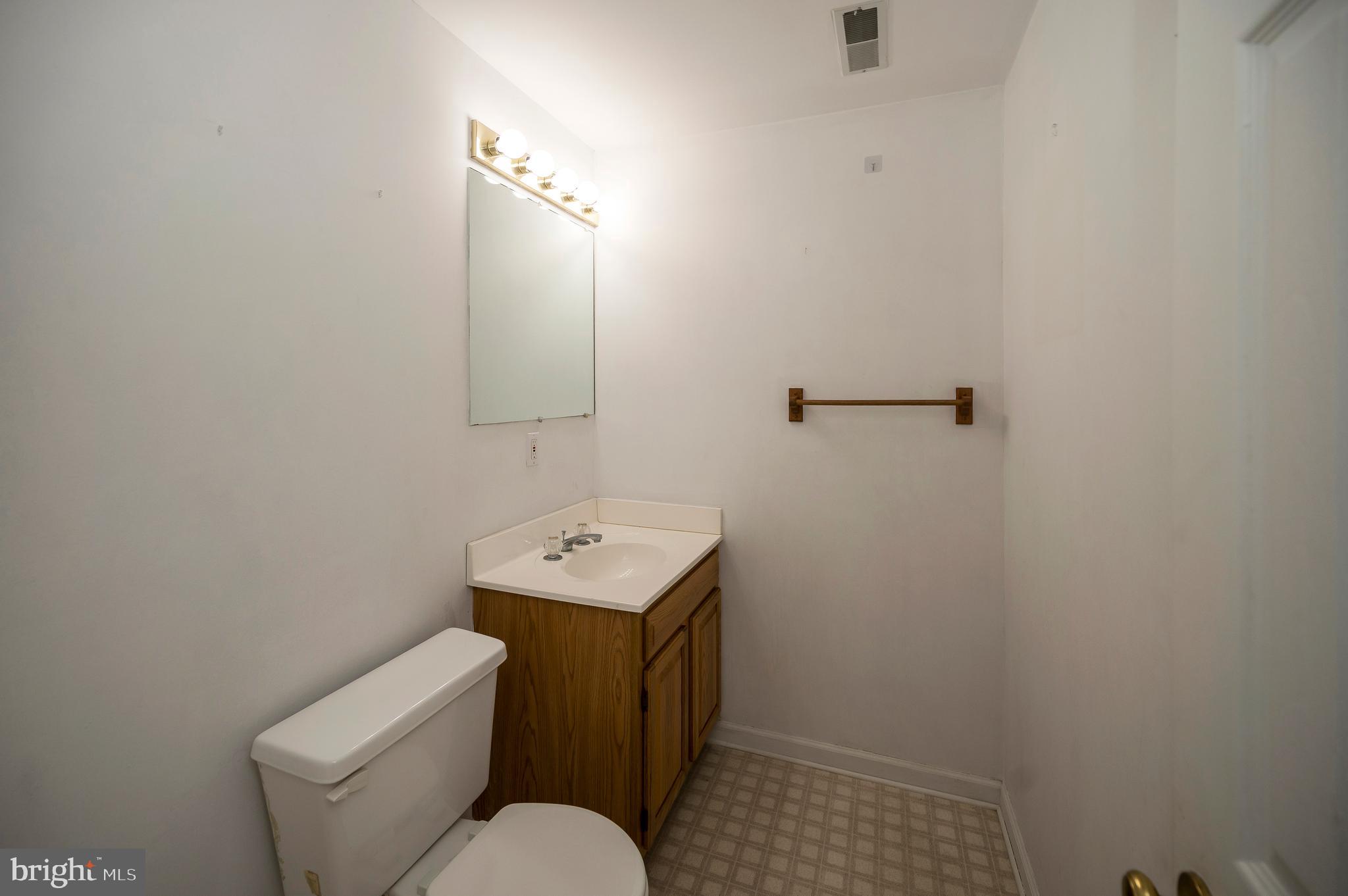 104 Dent Road Stafford, VA 22554 - Photo 115 of 118 a bathroom with a toilet sink and mirror