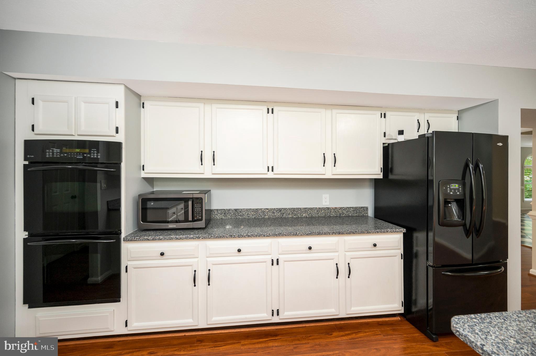 104 Dent Road Stafford, VA 22554 - Photo 23 of 118 a kitchen with granite countertop a refrigerator stove and microwave