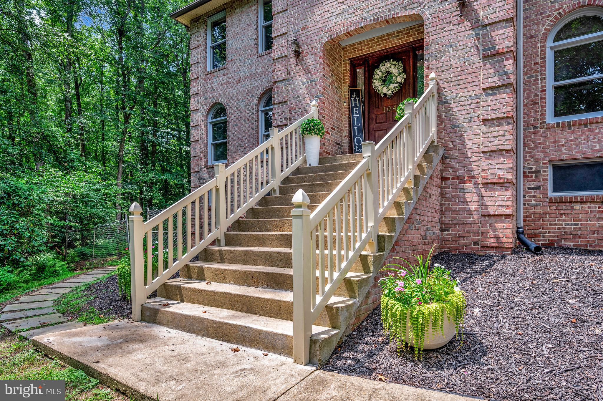 104 Dent Road Stafford, VA 22554 - Photo 3 of 118 a view of a house with brick walls and wooden fence