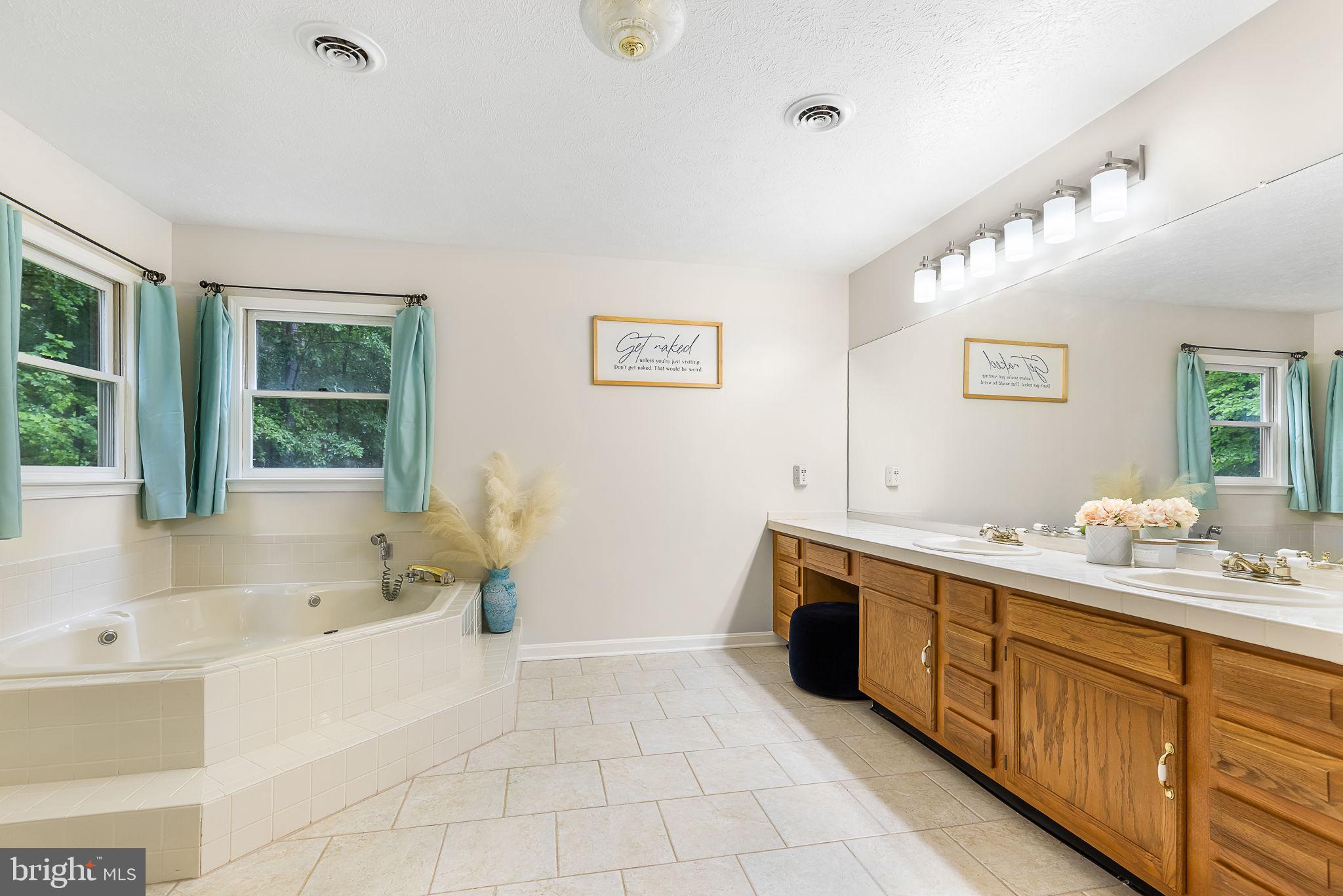 104 Dent Road Stafford, VA 22554 - Photo 33 of 118 a spacious bathroom with a tub sink and mirror