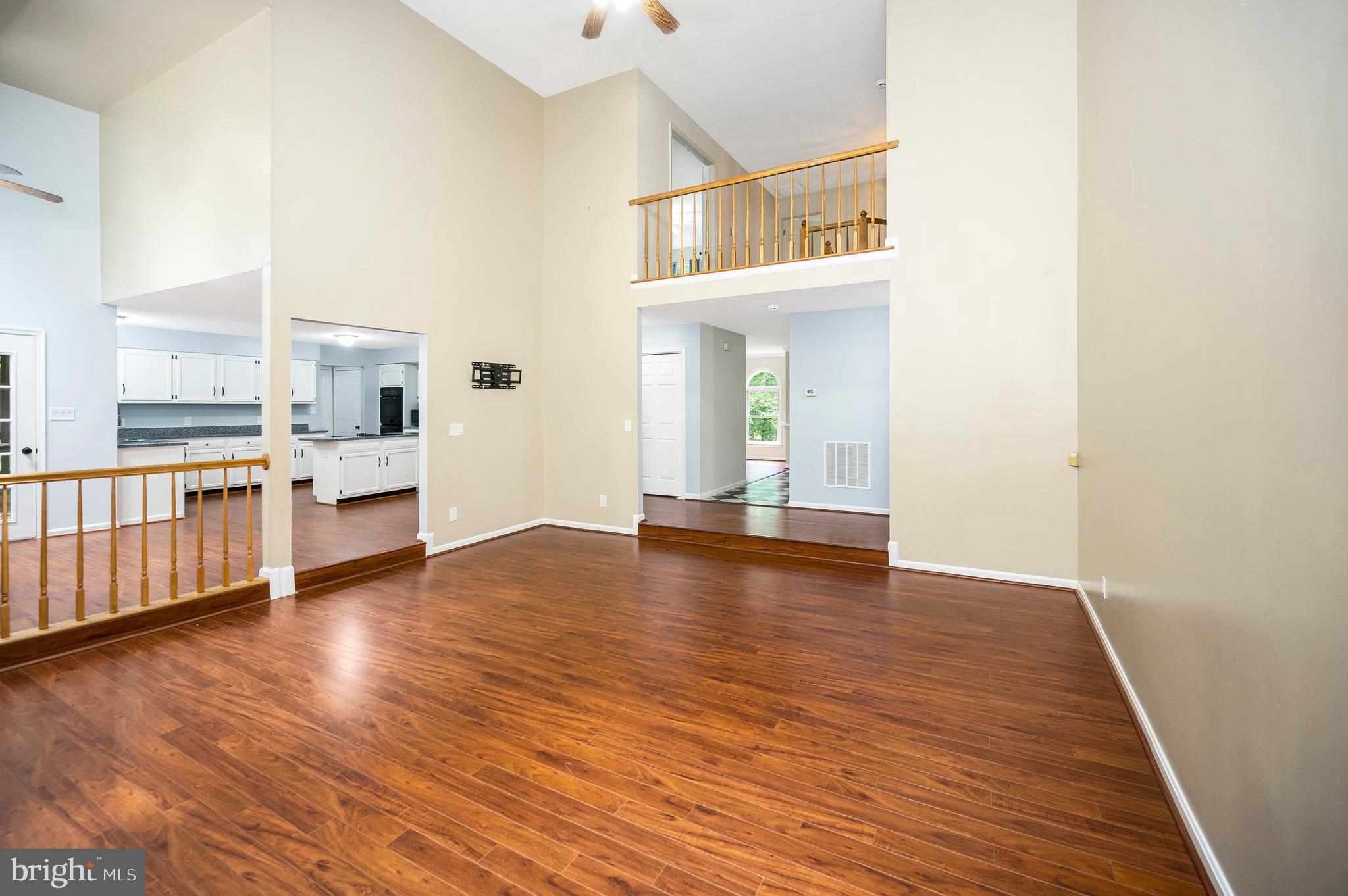 104 Dent Road Stafford, VA 22554 - Photo 94 of 118 a view of a hallway with wooden floor and a kitchen