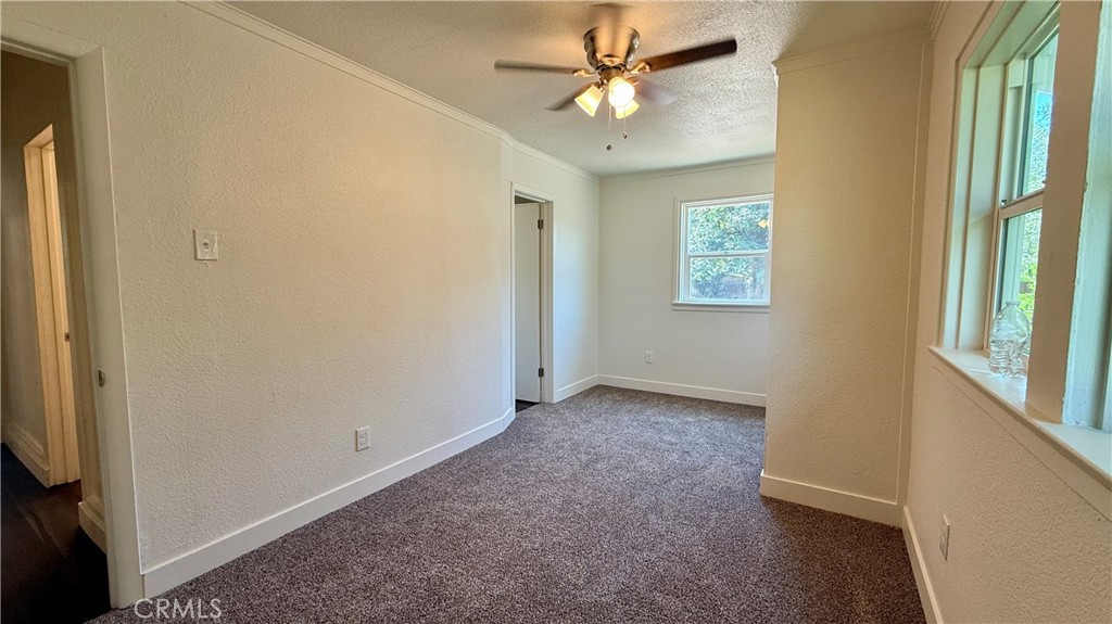 4542 Bandini Avenue Riverside, CA 92506 - Photo 18 of 22 an empty room with windows and fan