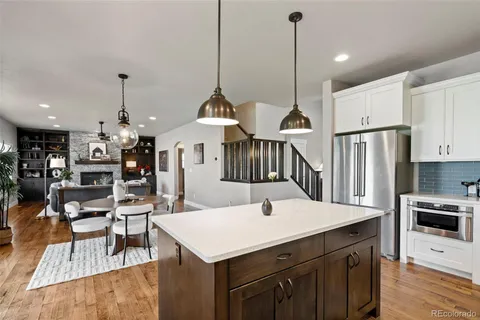 a kitchen with a table chairs stainless steel appliances and cabinets