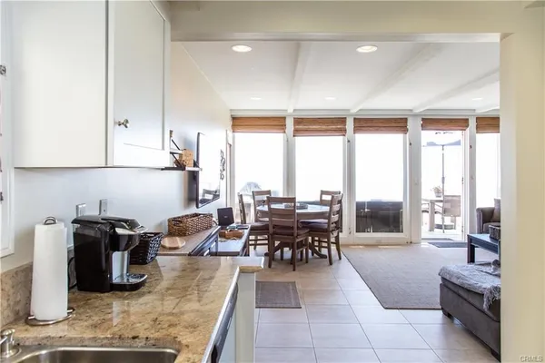 a kitchen with stainless steel appliances granite countertop sink table and chairs