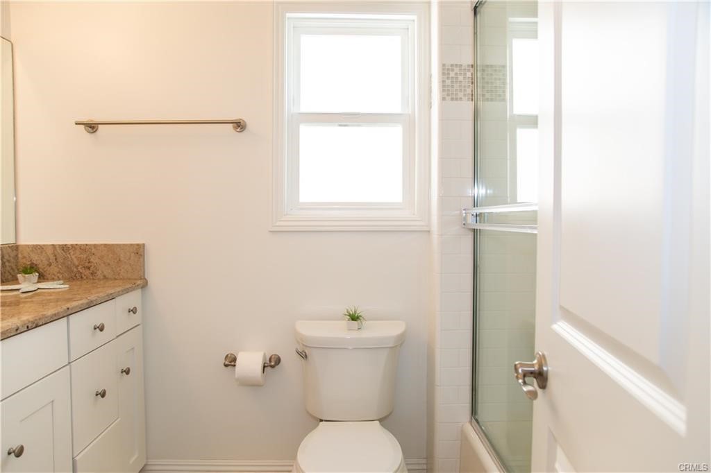 35 Surfside Avenue Surfside, CA 90743 - Photo 18 of 34 a bathroom with a toilet a sink and a window