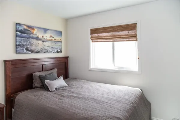 a bedroom with a bed and window