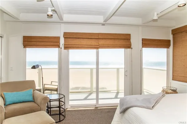 a bedroom with furniture and a large window