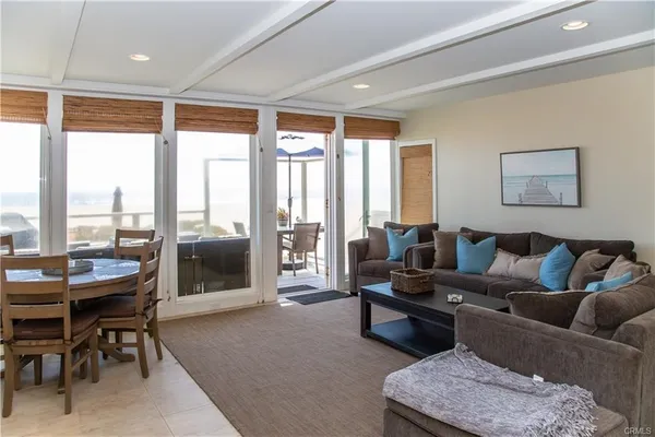 a living room with furniture and a floor to ceiling window