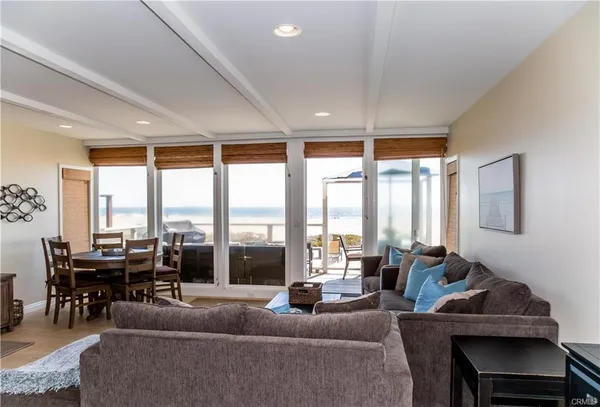 a living room with furniture and large windows