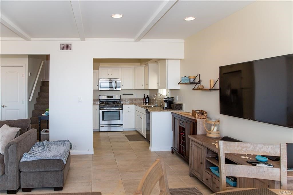 35 Surfside Avenue Surfside, CA 90743 - Photo 8 of 34 a kitchen with a refrigerator and a stove top oven