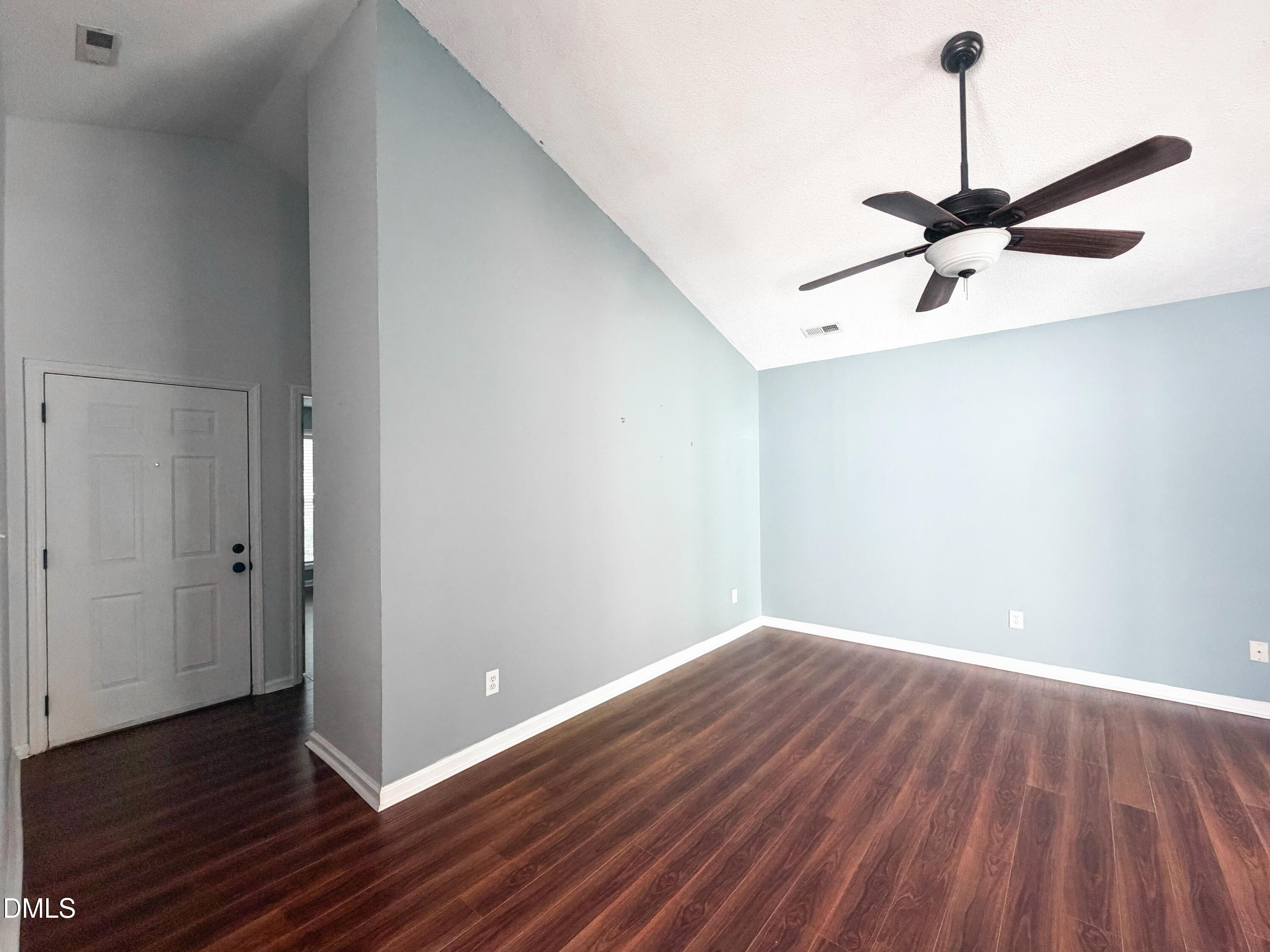 6304 Forest Ridge Drive Durham, NC 27713 - Photo 6 of 29 a view of a room with wooden floor a ceiling fan and a window