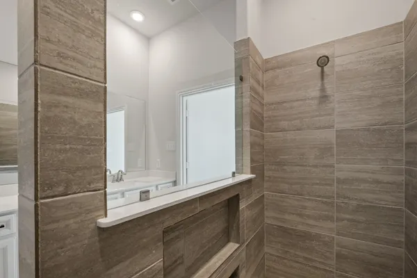 a bathroom with a shower and a sink