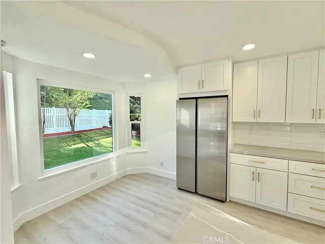 a kitchen with stainless steel appliances granite countertop a refrigerator and a stove