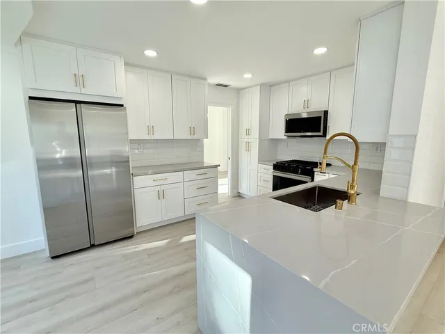 a kitchen with a refrigerator stove and microwave