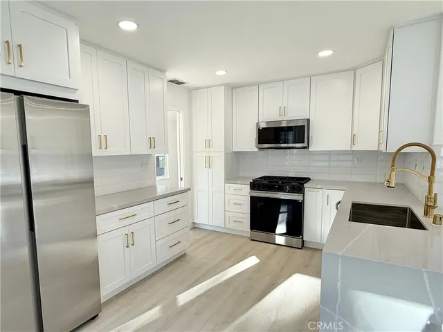 a view of walk in closet with wooden floor and cabinet