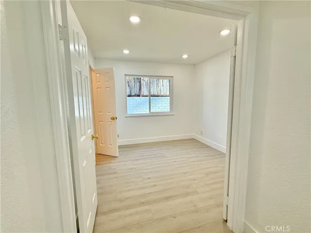 a bedroom with a bed and large flat screen tv