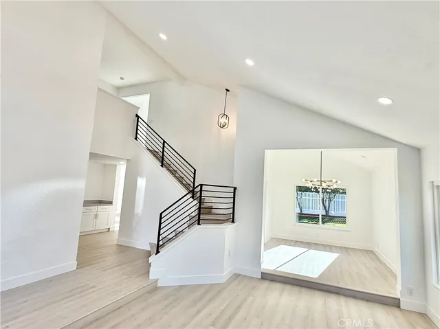 a spacious bathroom with a double vanity sink a mirror and a bathtub