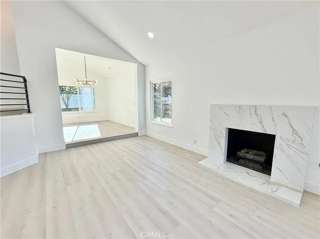 a view of a dining room with furniture and a chandelier