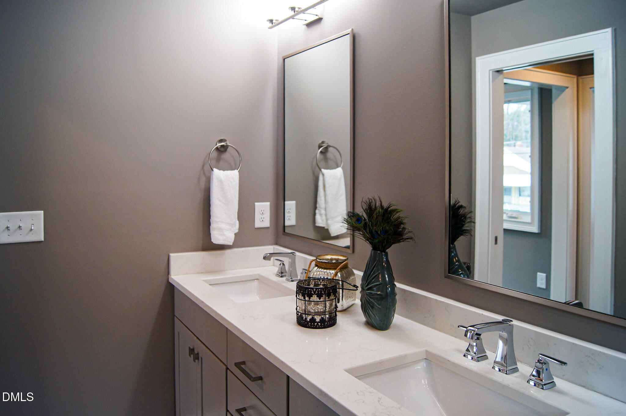 1208 Boyer Street Raleigh, NC 27610 - Photo 30 of 58 a bathroom with double vanity sinks and a mirror