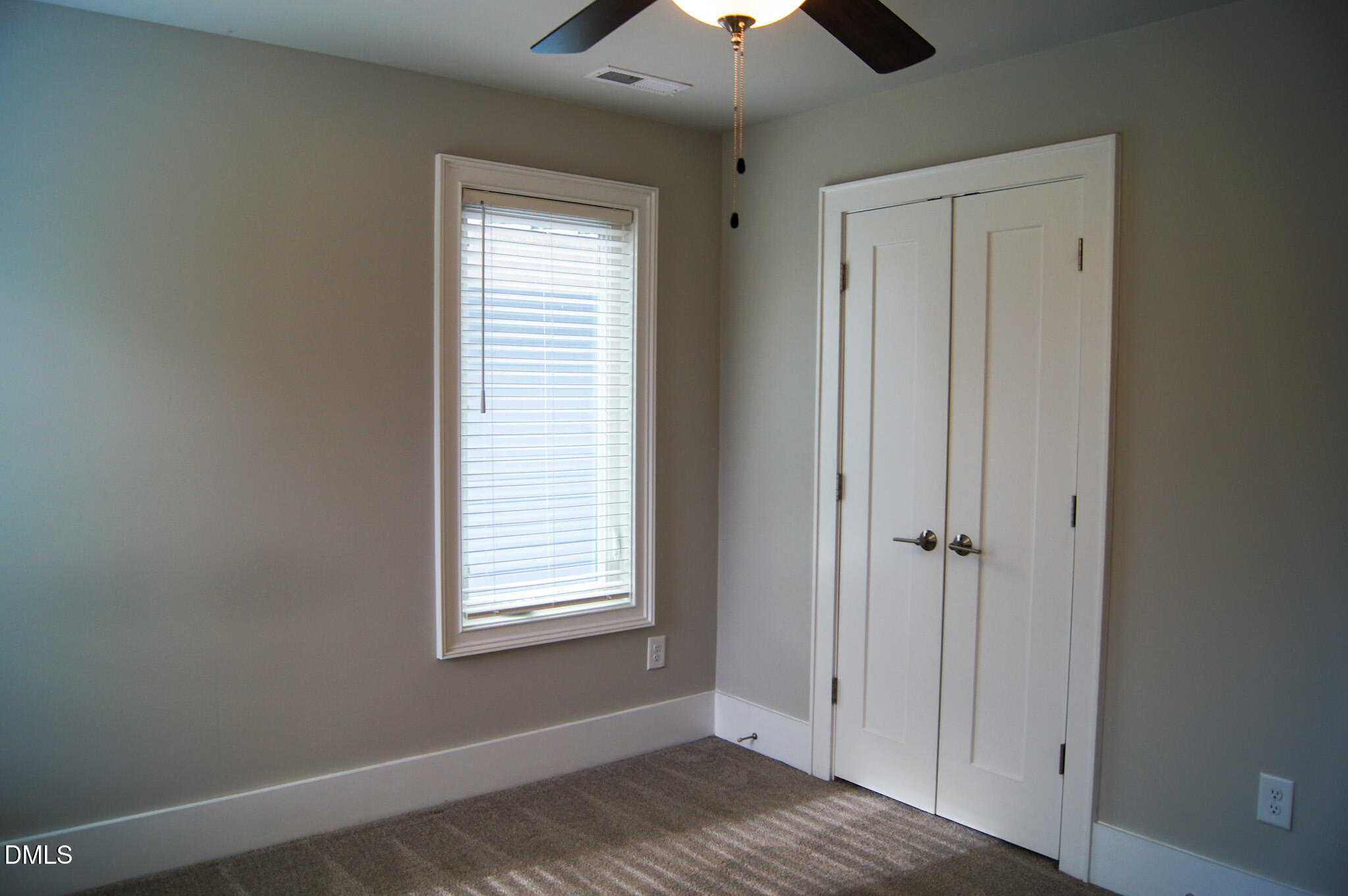 1208 Boyer Street Raleigh, NC 27610 - Photo 33 of 58 a view of an empty room with a window and a ceiling fan