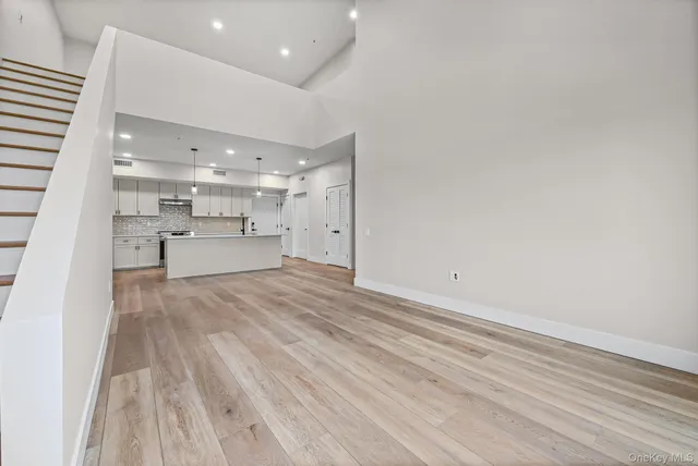 a view of kitchen and empty room