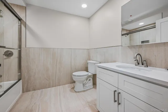 a bathroom with a toilet sink and shower