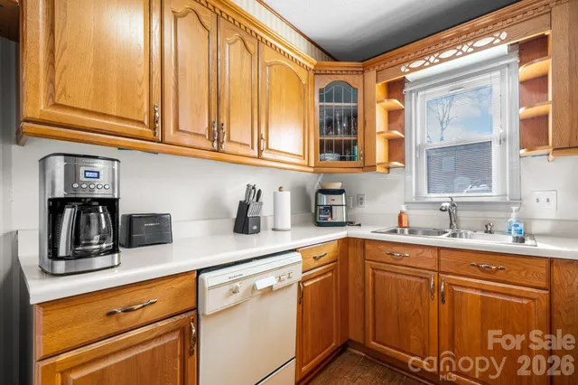 a kitchen with stainless steel appliances granite countertop a sink and cabinets