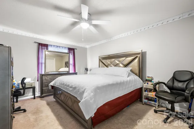 a bed room with a bed and chair