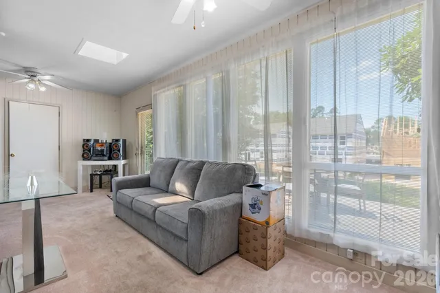 a living room with furniture and a glass door