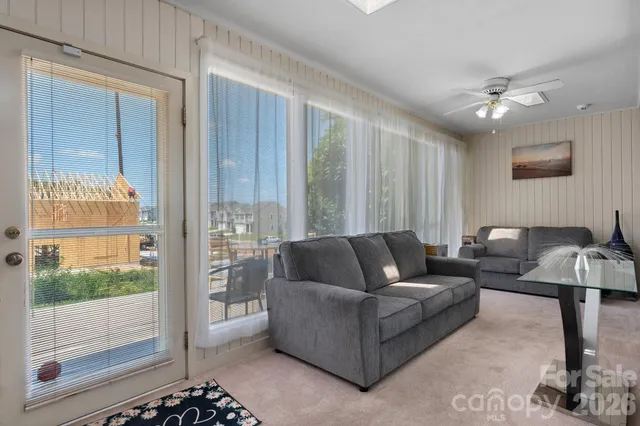 a living room with furniture and a glass door