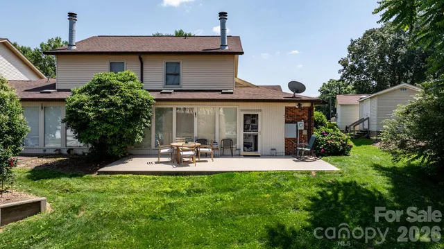 a front view of a house with a yard and outdoor seating