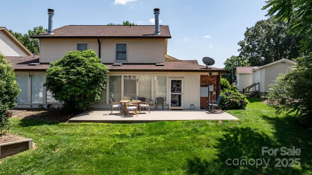 a front view of a house with a yard and outdoor seating