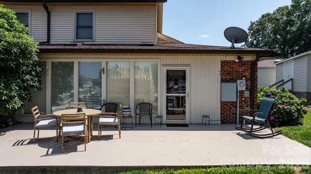 a backyard of a house with outdoor seating