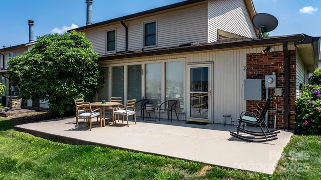a view of a house with backyard porch and sitting area