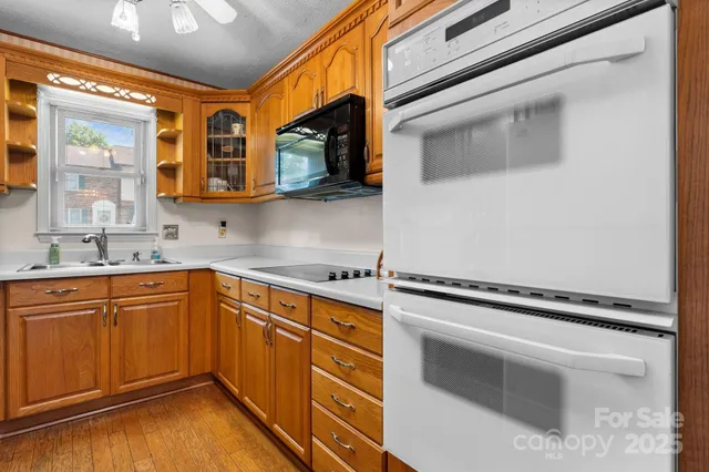 a kitchen with stainless steel appliances a stove microwave and sink