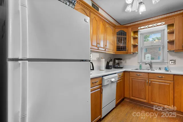 a kitchen with stainless steel appliances granite countertop a sink and cabinets