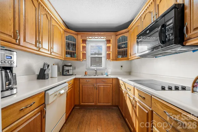 a kitchen with stainless steel appliances granite countertop a sink and cabinets